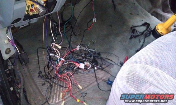 Mess of wires under dashboard, looks like an alarm system install gone wrong