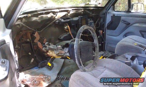Interior of a disassembled vehicle with exposed dashboard and steering wheel