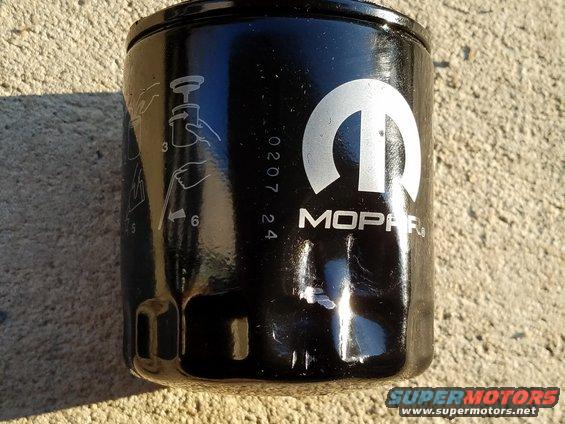 Black Mopar oil filter with installation instructions and date code 020724