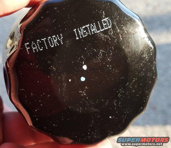 black oil filter with 'FACTORY INSTALLED' stamped on it