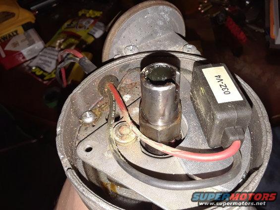Distributor cap interior with wires and a label reading 03Z-V4