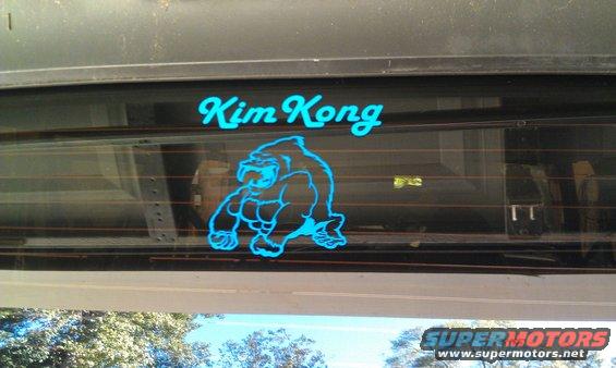 blue decal of a gorilla and text 'Kim Kong' on rear window