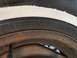 1987 Ford Crown Victoria LTD - Close-up of a tire and rusty wheel rim with size information visible on the sidewall.