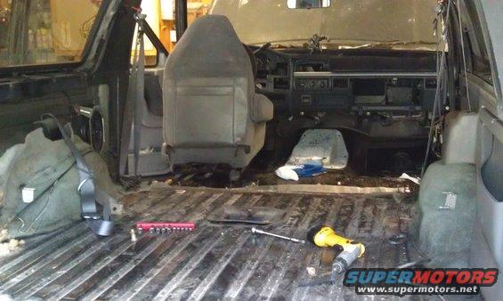 Interior of a disassembled 1992 Ford Bronco with tools on the floor