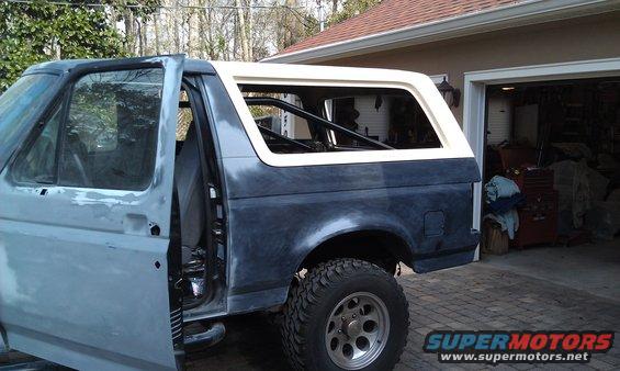 1995 Ford Bronco rear section with door open, parked in driveway