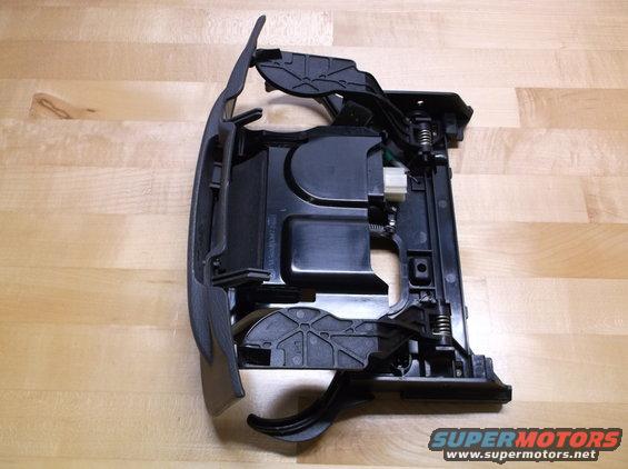 Black plastic car interior part with springs and levers