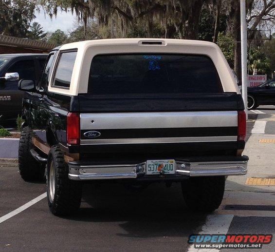 1990s Ford Bronco rear view, black with tan top, lifted suspension, Florida license plate 537 4UO
