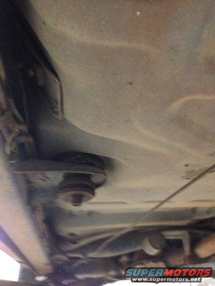 Underside view of a car, showing some suspension components and exhaust pipe