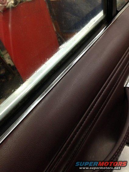 1988 Ford Crown Victoria LTD interior door panel with maroon upholstery and chrome trim