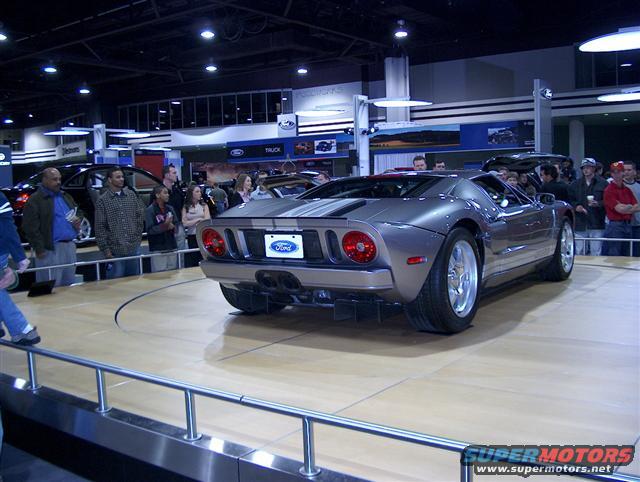 Rear view of a silver Ford GT on display at an auto show
