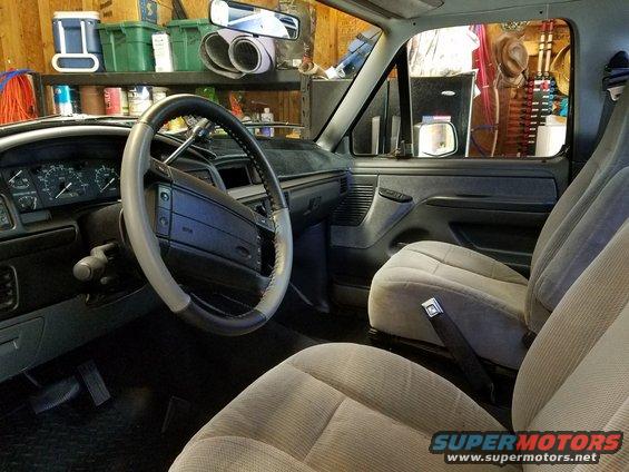 Interior of a 1995 Ford Bronco showing dashboard, steering wheel, and seats