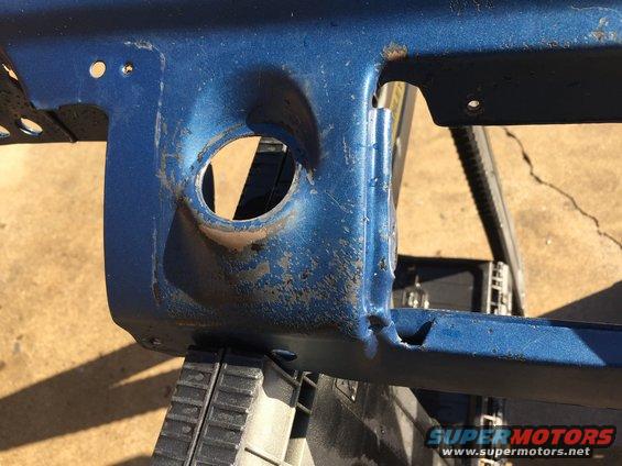 Blue metal part with circular cutout, possibly from a vehicle dashboard