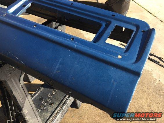 Blue metal panel with rectangular cutouts, resting on black supports