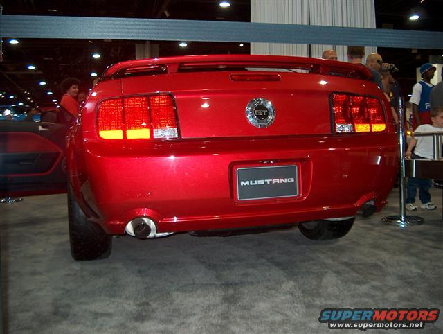 Red Ford Mustang GT rear view with 'MUSTANG' badge and GT emblem