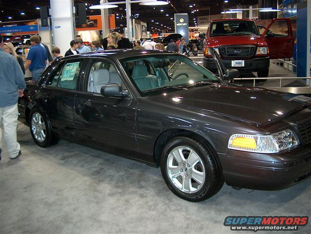 Dark gray 2001 Ford Crown Victoria sedan on display at an auto show