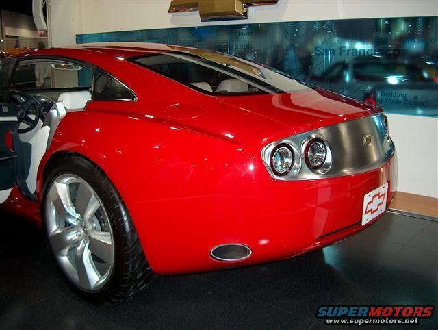 Red concept car rear view with chrome accents and dual exhaust pipes. Chevrolet badge visible