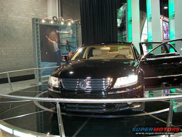 Black Volkswagen sedan with doors open on display