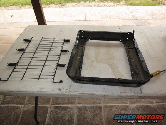 car seat frame and a detached seat spring assembly on a table