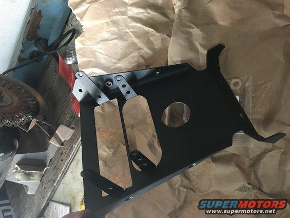 Black metal part with paper wrapping and SuperMotors logo