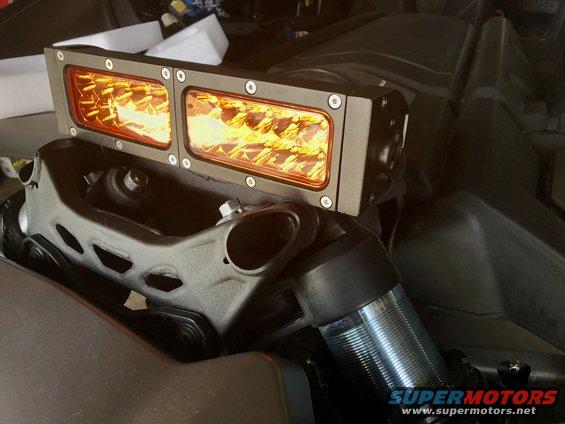 Off-road light bar with amber LEDs mounted on vehicle suspension components