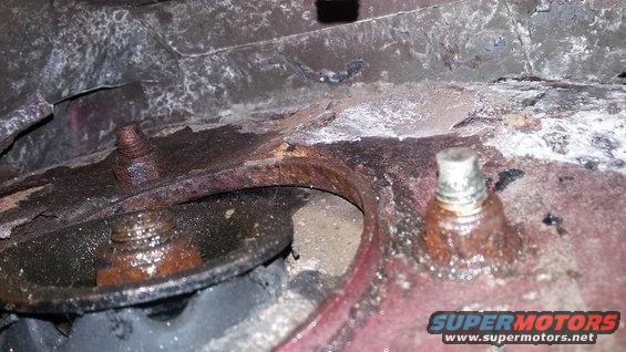 rusted metal frame with bolts and some white residue
