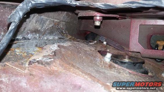 Rusted metal frame with bolts and wiring, Supermotors logo visible