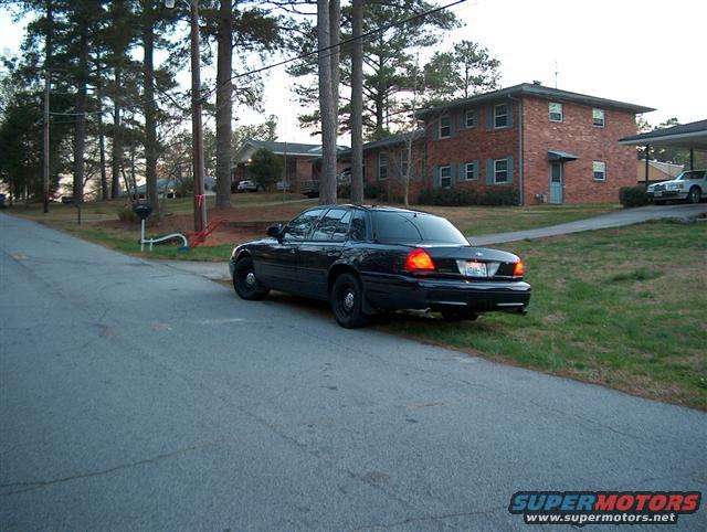 Black 2001 Ford Crown Victoria, rear view, parked on street