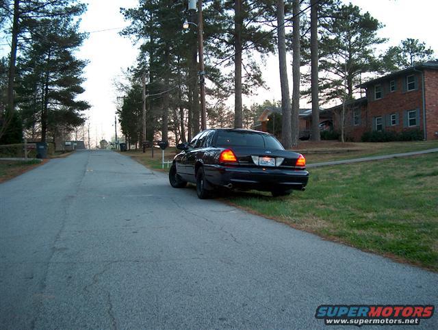 Black 2001 Ford Crown Victoria parked on the side of a residential street