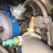 1979 Ford Ranchero - Close-up view of various engine components, including a distributor and sensors, with visible hoses and wiring.
