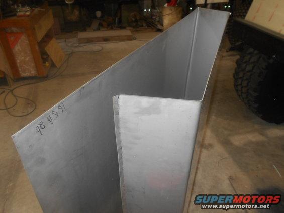 Sheet metal panel with handwritten markings '96 6A ab' and a tire visible in the background