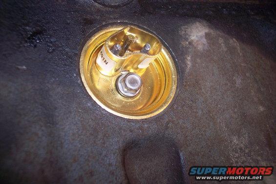 Gold oil pressure sensor with a white label reading "401N"