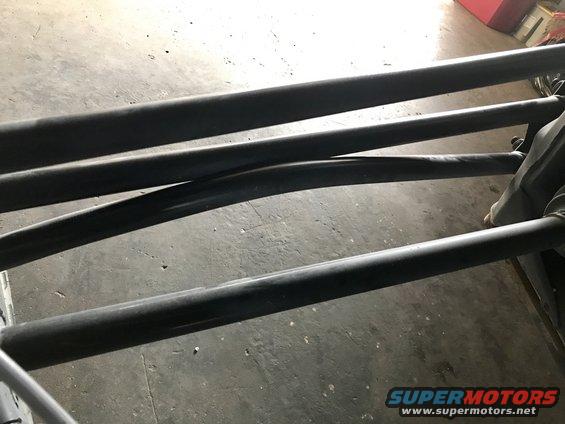 Black roll cage bars inside a vehicle