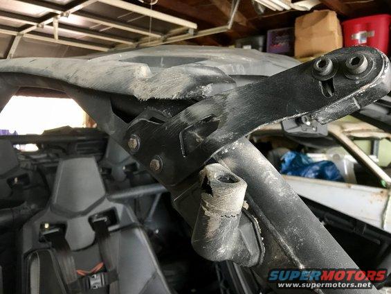 Damaged black roll cage and interior of an off-road vehicle