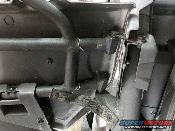 Interior roll cage and door panel with strap