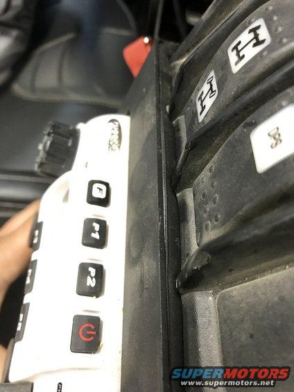 Interior view of vehicle shifter with H markings and white control panel with F, P1, P2, and power buttons