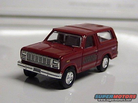 Red 1979 Ford Bronco toy on a white surface. Text on the side reads 'FIELD & STREAM'
