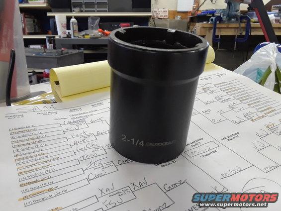 Black socket wrench with 2-1/4 AUTO-CRAFT markings sits on a paper tournament bracket