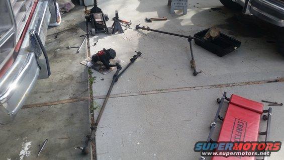 Steering linkage and gearbox disassembled on concrete floor