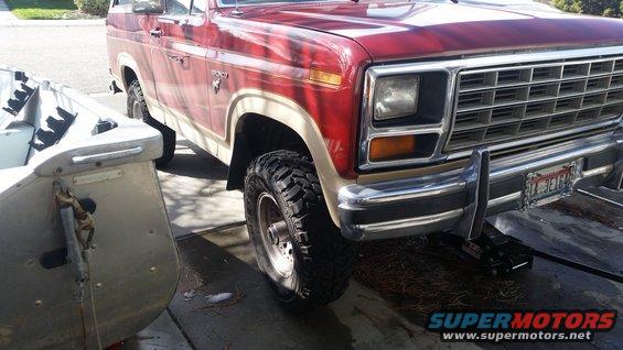 Red and tan 1985 Ford Bronco front quarter view with off-road tires