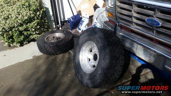 1980s Ford Bronco front grille and bumper with two large off-road tires on the ground