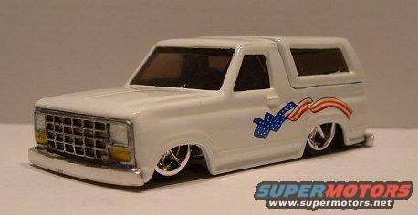 White Ford Bronco model with American flag graphics on side