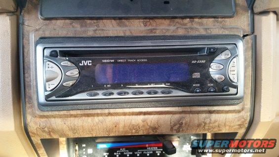 JVC car stereo installed in wood-grain dash panel
