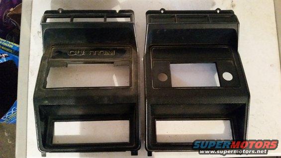 Two black plastic dashboard trim pieces, one labeled "CUSTOM", with cutouts for radio and gauges