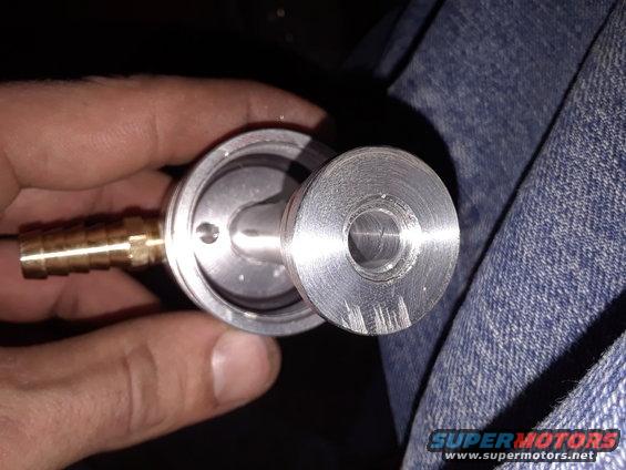 metal fitting with brass barb, held in hand