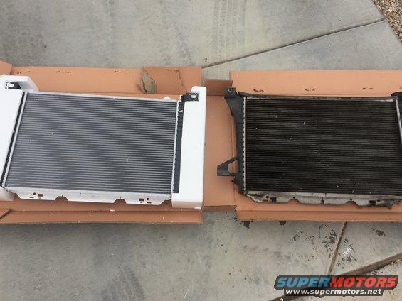 New radiator in box next to old, dirty radiator