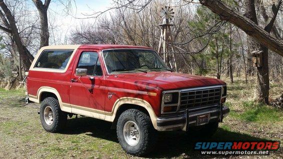 1985 Ford Bronco parked outdoors with a windmill in the background