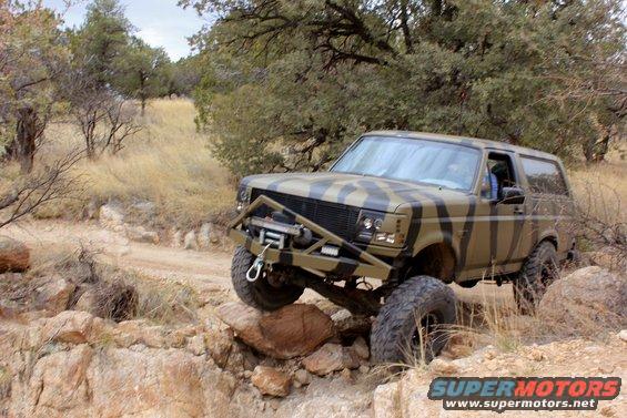 Camouflaged Ford Bronco on rocky terrain