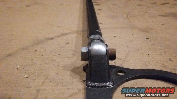 Close-up of a black car strut bar with adjustable joint