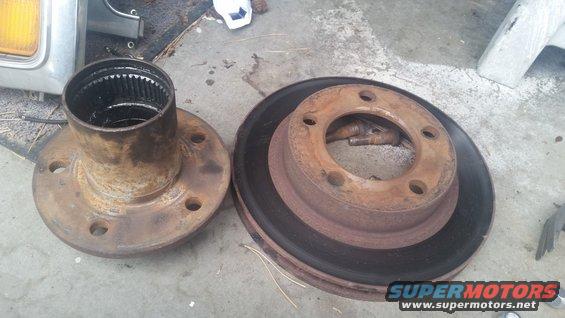 Rusted brake rotor and hub assembly on concrete