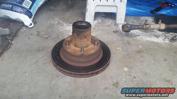 Rusty brake rotor and hub assembly on concrete floor